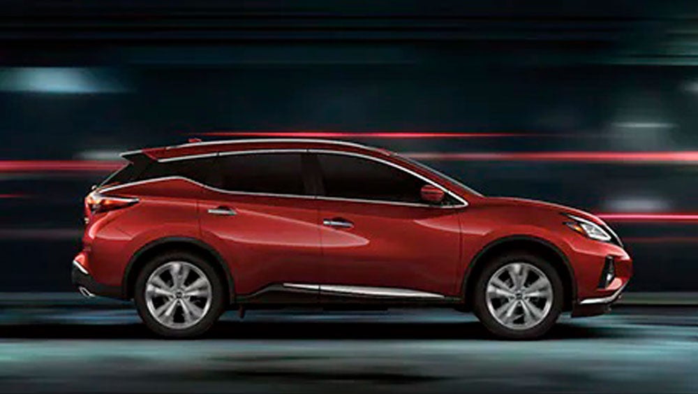 2023 Nissan Murano shown in profile driving down a street at night illustrating performance. | Scott Clark Nissan in Charlotte NC